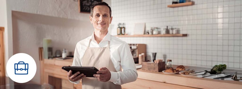 Business owner reviewing insurance policy documents at the start of the year.