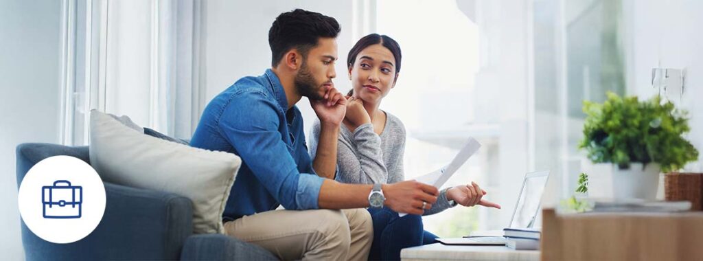 A confident and determined person reviewing documents at their business while looking for how to get commercial insurance without a credit history.