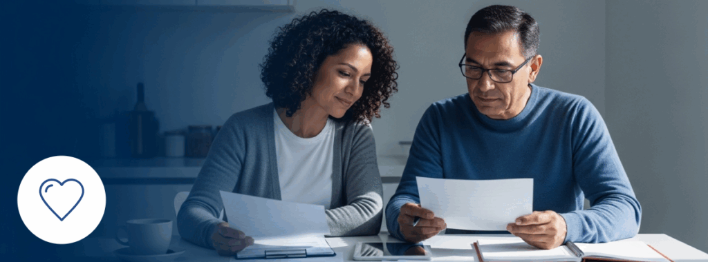 Term life insurance vs whole life planning by Latino couple at kitchen table