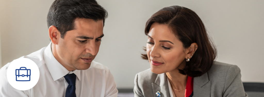 Professional couple reviews tax-deductible business insurance in modern office 2026