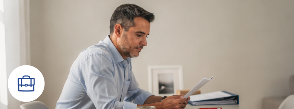 Man reviewing workers' compensation rates Florida 2026 in home office