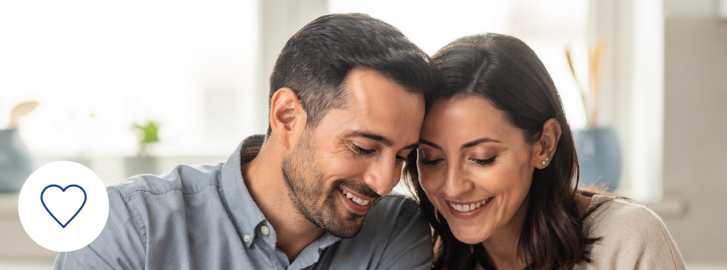 Couple reviewing life insurance documents to protect mortgage in modern home