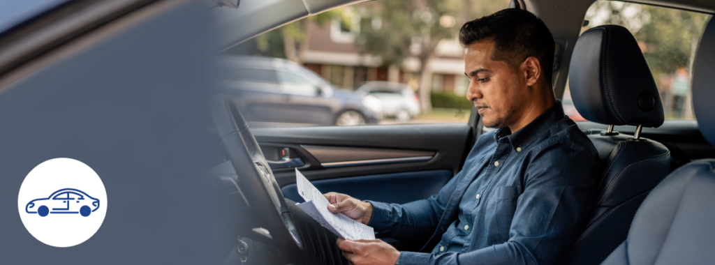 calm Latin driver reviewing car documents inside modern blue toned vehicle