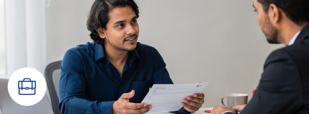 Latin small business owner reviewing documents with advisor small business insurance quote
