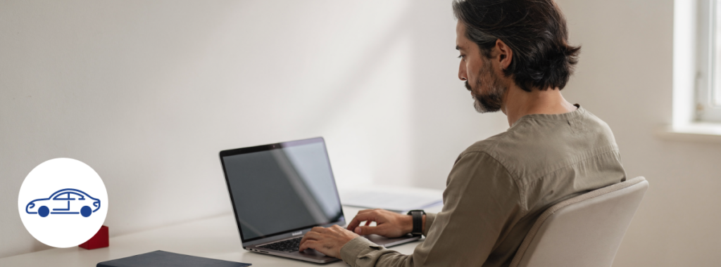 Latin adult reviewing car insurance options on laptop at minimalist home desk