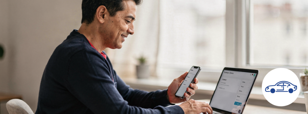Latin adult working on laptop and phone reviewing car insurance online quotes